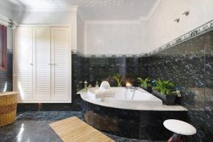 a large bathroom with a tub with plants at Las Monarcas in Teror +22 photos