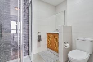 a bathroom with a toilet and a shower at Corralejo Ian’s Dreams in Corralejo +48 photos