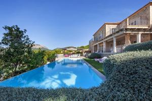 a swimming pool in the yard of a house at Villa Oasis Del Mar in El Toro