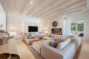 a living room with two couches and a fireplace at Villa Oasis Del Mar in El Toro
