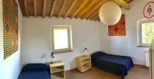 a bedroom with a blue bed and a window at La Casa Rossa 2 in Bibbona