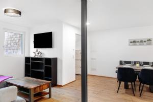 a living room with a table and a dining room at Apartement Ben´s Auszeit Top 4 in Umhausen