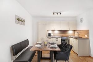 a kitchen and dining room with a table and chairs at Apartement Ben´s Auszeit Top 4 in Umhausen