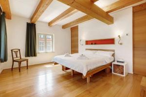 a bedroom with a large bed and a wooden floor at Ferienhaus im Vorwerk Nickern in Dresden