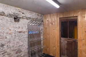 a room with a stone wall with a metal rack at Apartement Ben´s Auszeit Top 4 in Umhausen +19 photos