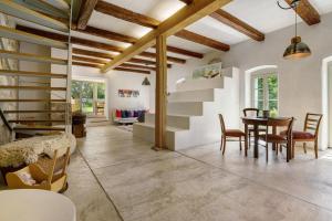 a living room with a staircase and a table and chairs at Ferienhaus im Vorwerk Nickern in Dresden