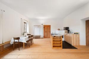 a kitchen and dining room with a table and chairs at Ansitz Baumannhof Apt Erker Suite in Falzes +35 photos