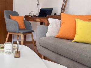 a living room with a couch and a desk with a laptop at Lichtdurchflutete Wohnung in Kempten