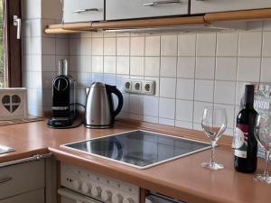 a kitchen counter with a sink and two wine glasses at Lichtdurchflutete Wohnung in Kempten