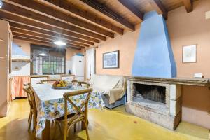 a living room with a table and a fireplace at La Carrasca - Naranja in Catral