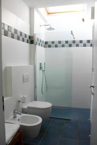 a white bathroom with a toilet and a shower at Re Piano appartamento Le Colline in Modigliana +15 photos