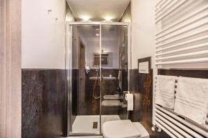 a bathroom with a shower and a toilet and a sink at Chalet Osmar Suite 1 in Campitello di Fassa +24 photos