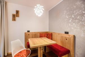 a dining room with a wooden table and chairs at Chalet Osmar Suite 1 in Campitello di Fassa