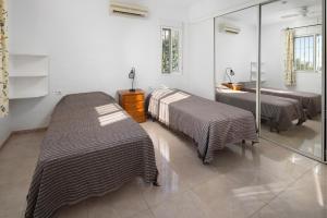 two beds in a room with a mirror at Finca Carrion in Periana +25 photos