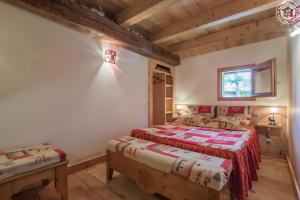 a bedroom with two beds and a window at Chalet Blanchon in Montricher-Albanne