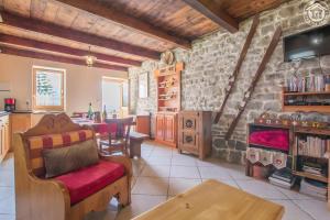 a living room with a stone wall at Chalet Blanchon in Montricher-Albanne
