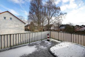 a white fence with a fire hydrant in the snow at Ferienwohnung Nordmeer in Kappeln