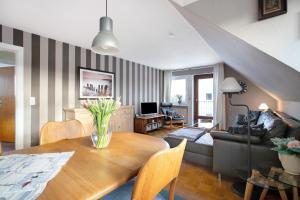a living room with a vase of flowers on a table at Ferienwohnung Nordmeer in Kappeln