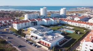 an aerial view of a city with buildings and the ocean at Baleal Breeze Apartment in Ferrel