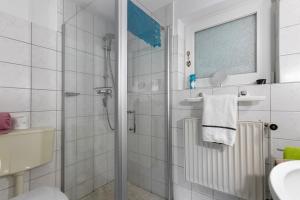 a bathroom with a shower and a sink at Haus Gartenidylle in Wesselburen +14 photos