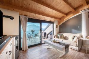 a living room with a couch and a table at Summer and Winter in Perledo