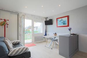 a living room with a couch and a table at Appartement en front de mer in Plérin