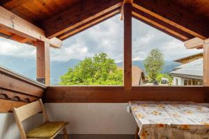 a window on a porch with a table and a chair at Galtinerhof in Rodengo