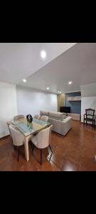 a living room with a table and a couch at Origens - Alojamento Local in Bragança