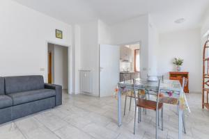 a living room with a glass table and a couch at Casa Claudia a Porto Azzurro in Porto Azzurro