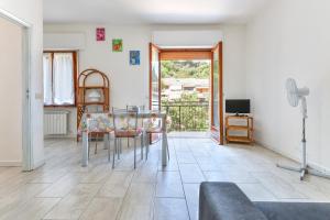 a dining room with a table and chairs and a television at Casa Claudia a Porto Azzurro in Porto Azzurro