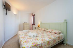 a bedroom with a bed with two towels on it at Ferrera Suite in Cala Ferrera +22 photos