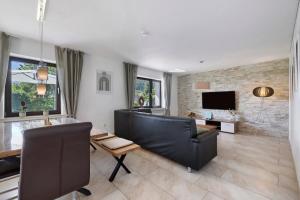 a living room with a couch and a television at Ferienwohnung Mayer in Albstadt