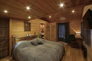 a bedroom with a bed in a log cabin at Chalet Pesse in Manigod