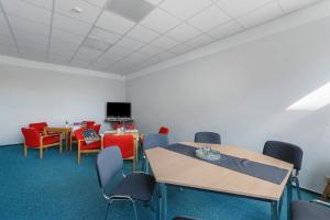 a conference room with tables and chairs and a tv at Ferienwohnungen Schönwald in Schönwald