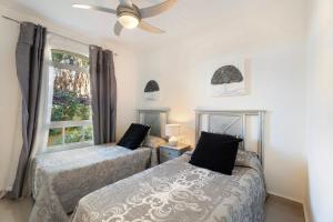 a bedroom with two beds and a window at Villa Romano in Adeje +30 photos