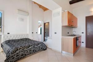 a bedroom with a bed and a sink and a tub at Serra Monolocale in Bonassola
