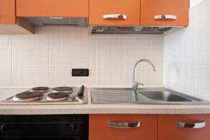a kitchen with a sink and a stove at Serra Monolocale in Bonassola +12 photos