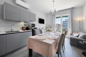 a kitchen and living room with a table and a kitchen and a dining room at Giaely in Borghetto Santo Spirito