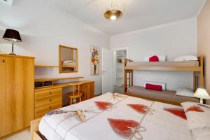 a bedroom with two beds and a desk and a bunk bed at Giaely in Borghetto Santo Spirito