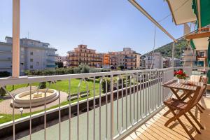 a balcony with a table and chairs and buildings at Giaely in Borghetto Santo Spirito