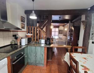 a kitchen with a counter top and a table at El Camino in Molinaseca