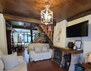 a living room with a tv and a fireplace at El Camino in Molinaseca