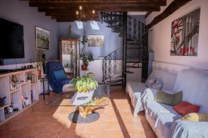 a living room with a couch and a table at Chambres D'hôtes Le Petit Puits in Cheverny