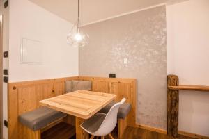 a dining room with a wooden table and chairs at Chalet Osmar Suite 2 in Campitello di Fassa