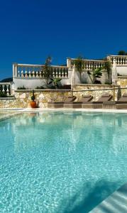 a large pool of water in front of a building at Coral Boutique Hotel in Vlorë