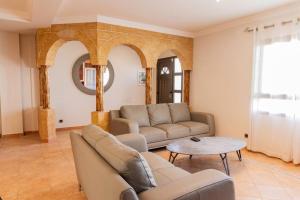 a living room with a couch and a table at Corralejo Ian’s Dreams in Corralejo