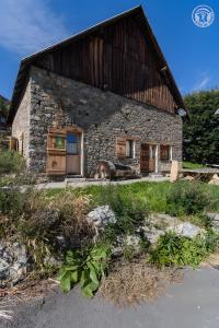 a stone house with a couch in front of it at Chalet Blanchon in Montricher-Albanne