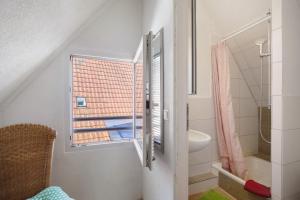 a bathroom with a window and a sink and a toilet at Ferienwohnung Sila 3 in Weinstadt +23 photos