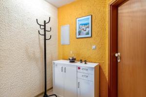 a bathroom with a white cabinet and a sink at Ferienwohnung Heilsbergblick in Hilzingen +39 photos