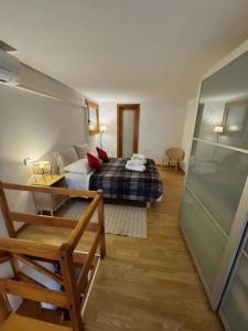 a bedroom with a bed and a desk in a room at Apartments San Biagio in Vicenza